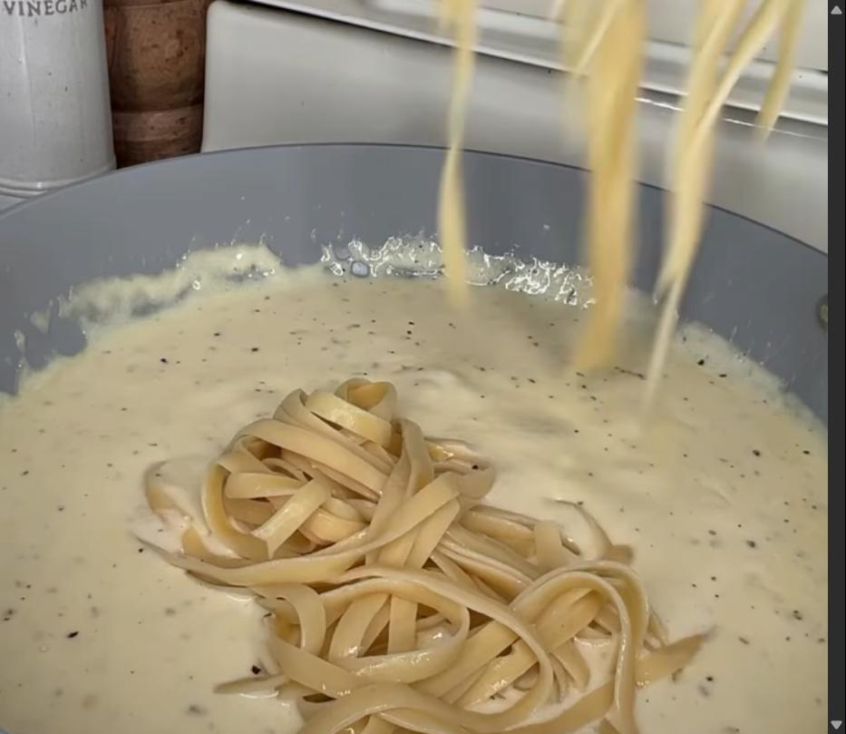 Step 2.1: Add cooked fettuccine noodles to the pan and toss to combine with the Alfredo sauce