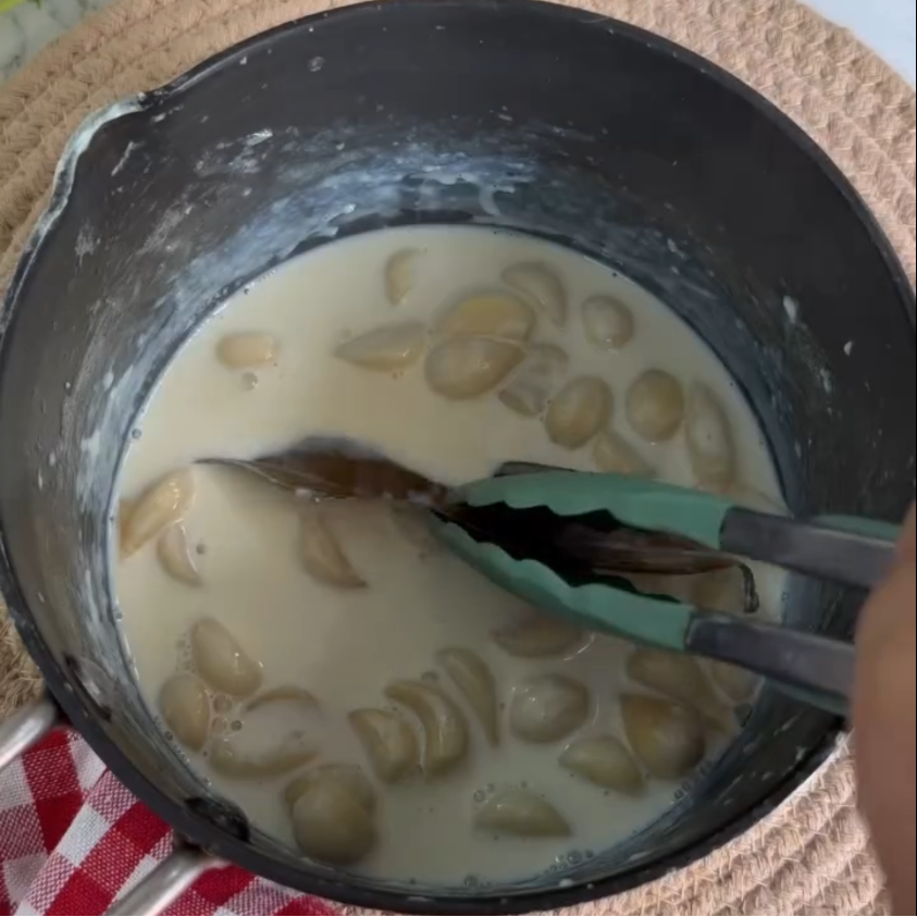 Step 1.1: Add peeled garlic cloves, full-fat milk, bay leaf, salt, and pepper to a pan
