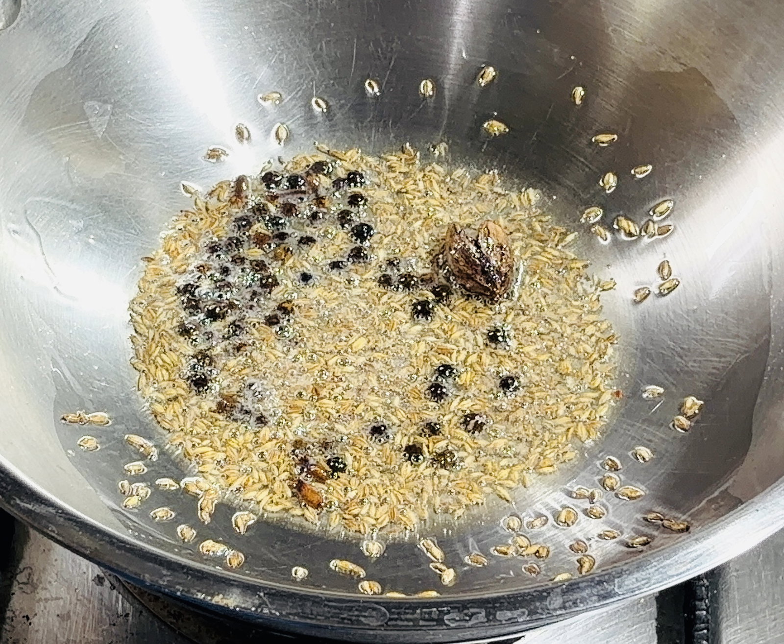 Step 2.1: Add cumin, black cardamom, cloves, and peppercorns