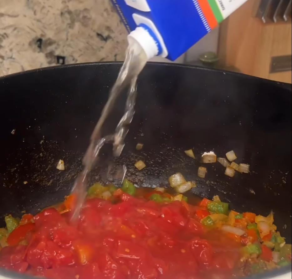 Step 2.1: Mix in diced tomatoes and chicken broth, then bring to a boil
