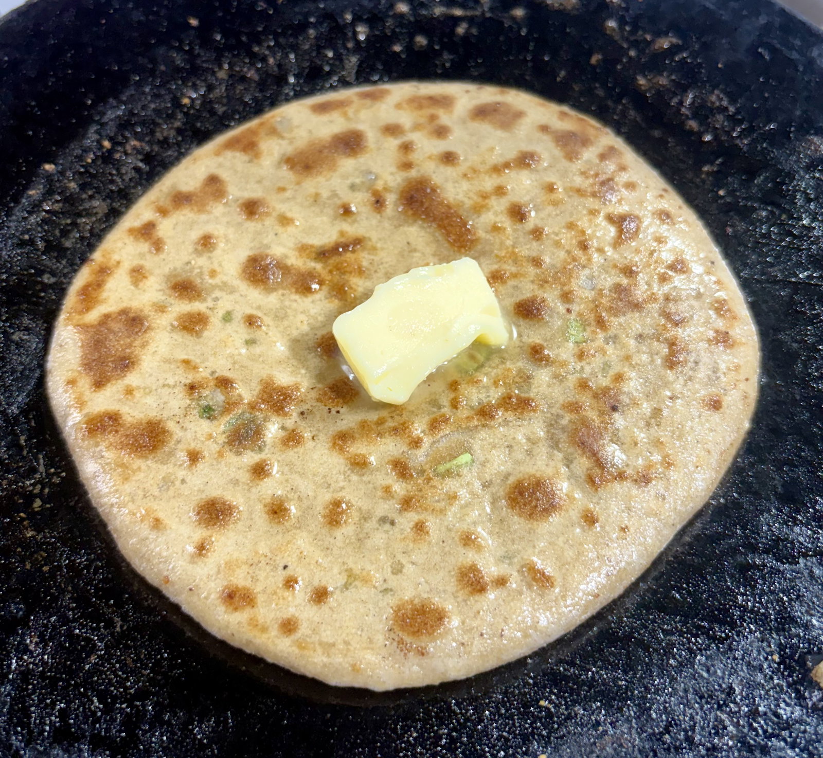 Step 4.2: Apply a teaspoon of ghee or oil on both sides