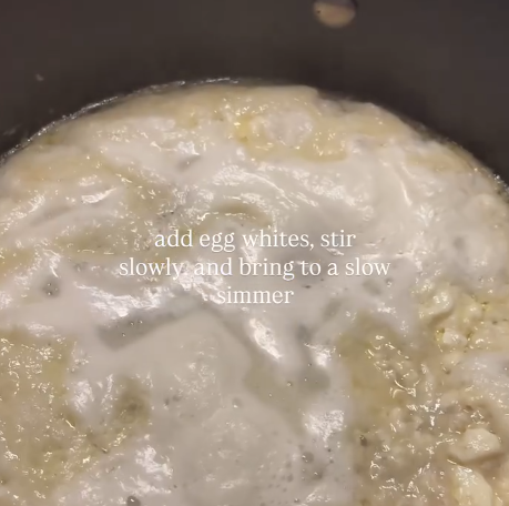 Step 1.1: Lightly beat egg whites and stir gently into the warm broth