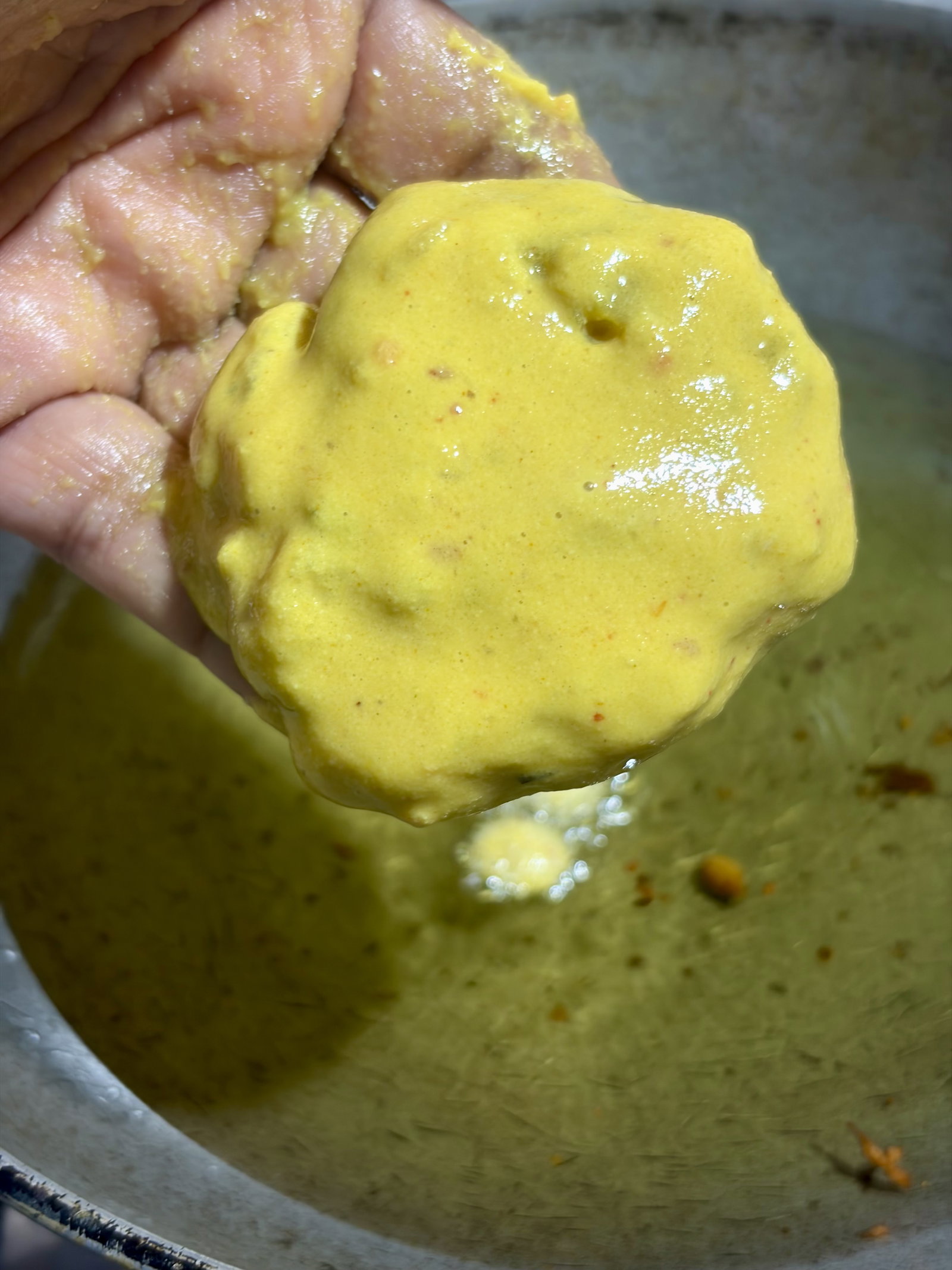 Step 3.1: Dip each potato ball into the batter, coat evenly, and gently slide it into the hot oil