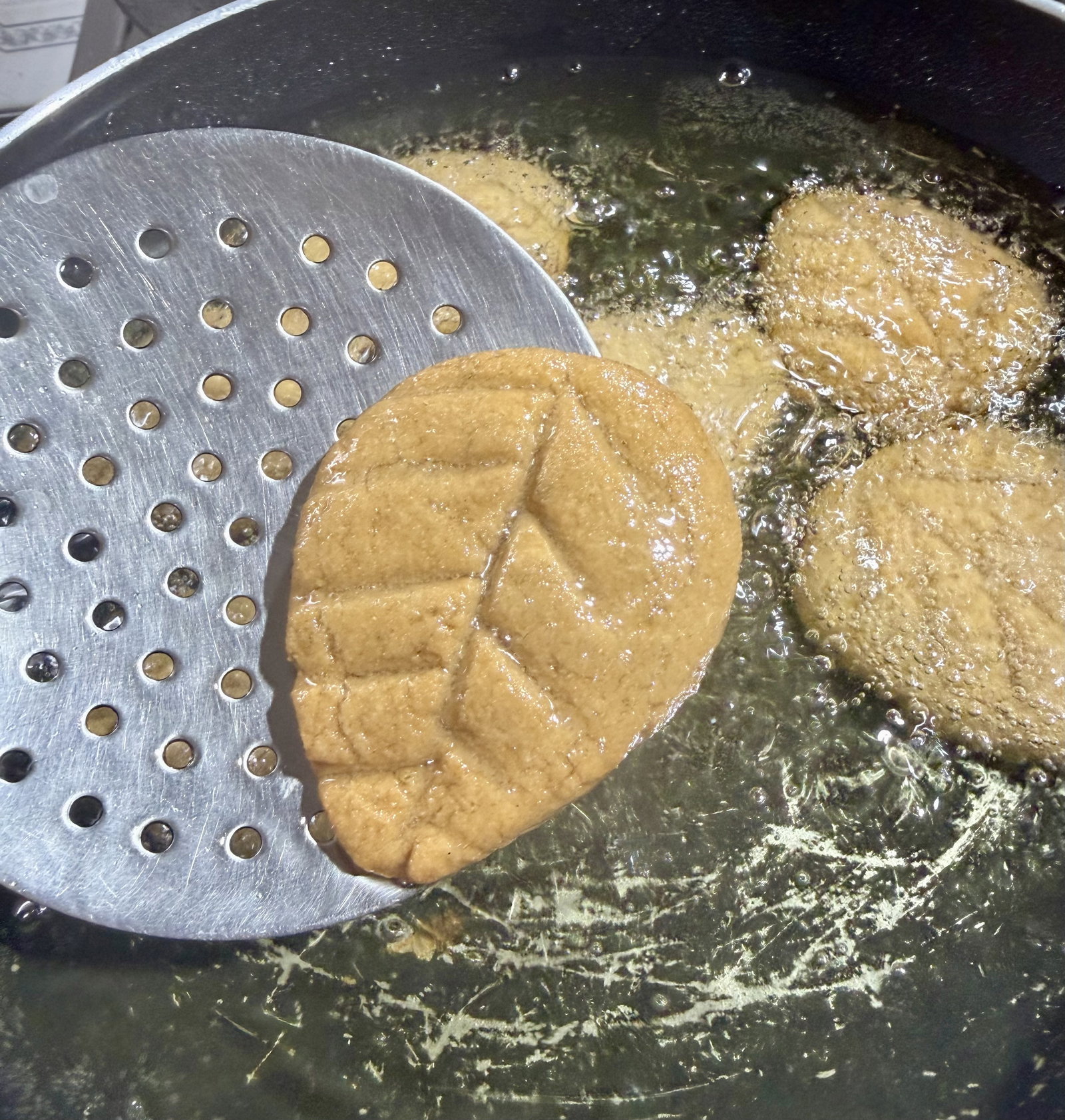 Step 5.1: Gently drop the shaped discs into the hot oil in batches