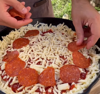 Step 2.1: Top with pizza sauce, grated parmesan, mozzarella, and pepperoni