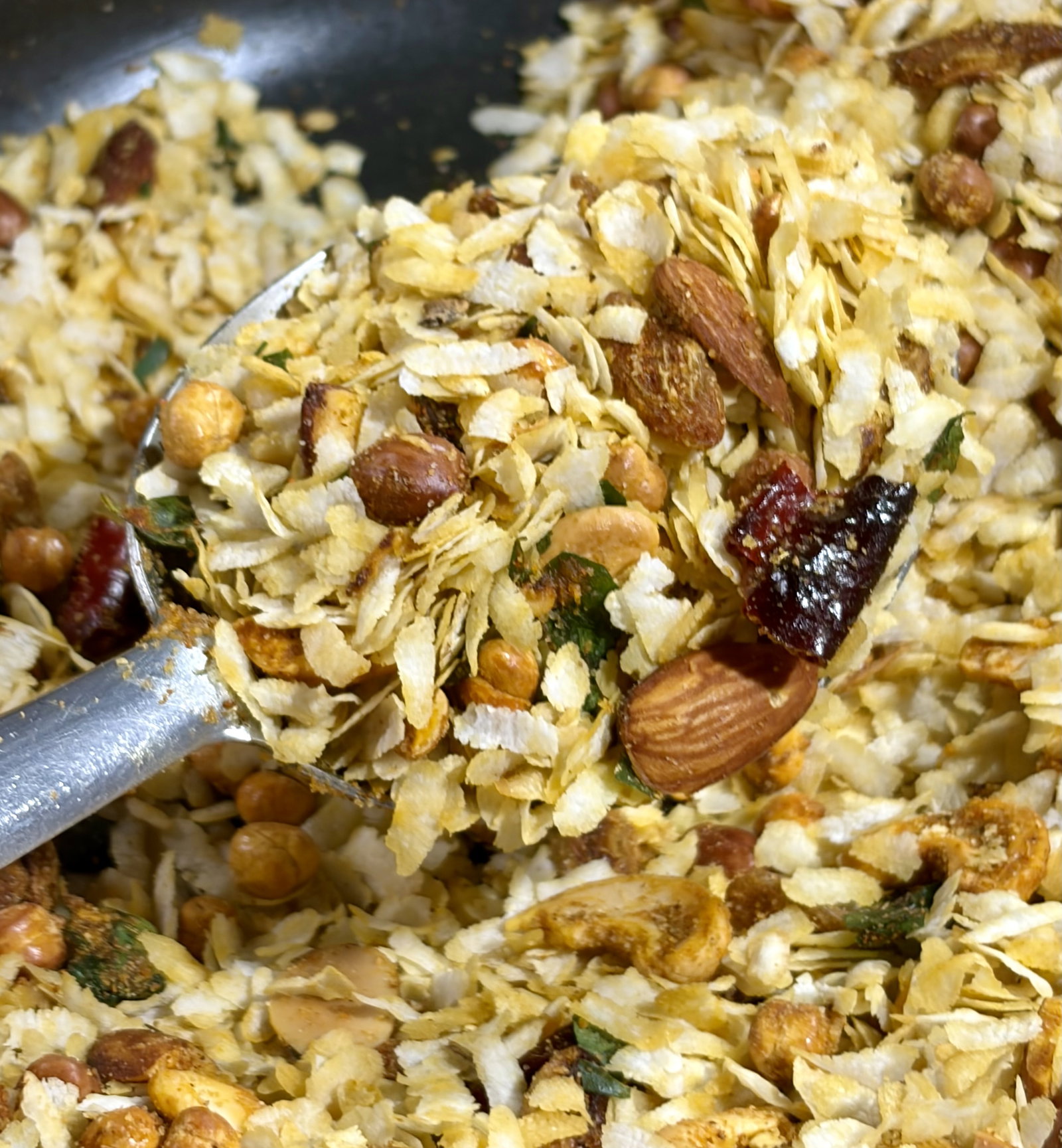 Step 4.1: Using two spatulas, gently toss everything together from the bottom up until the yellow turmeric hue coats the poha evenly