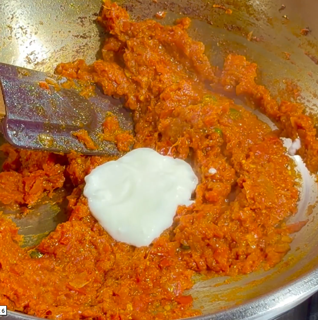 Step 2.1: Lower the heat and gradually add whisked curd, stirring continuously
