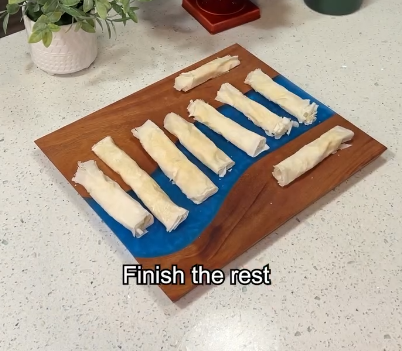 Step 2.1: Roll one side of the Yufka over the filling and moisten the end with water to seal
