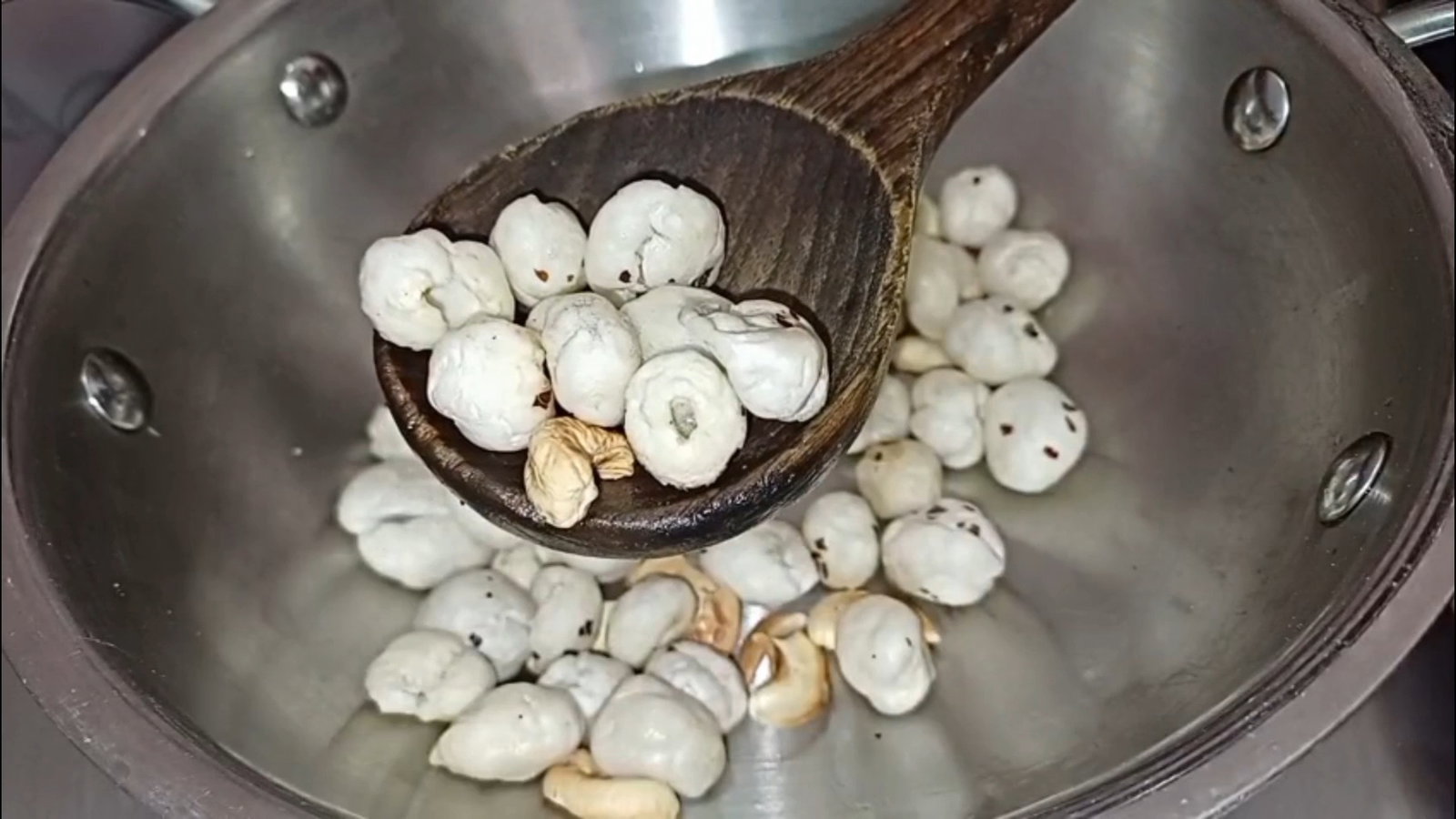 Step 1.1: Add makhana to the pan and roast until crisp