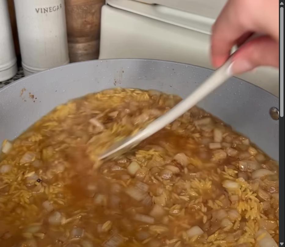Step 3.1: Pour in chicken broth and scrape brown bits from bottom of pan