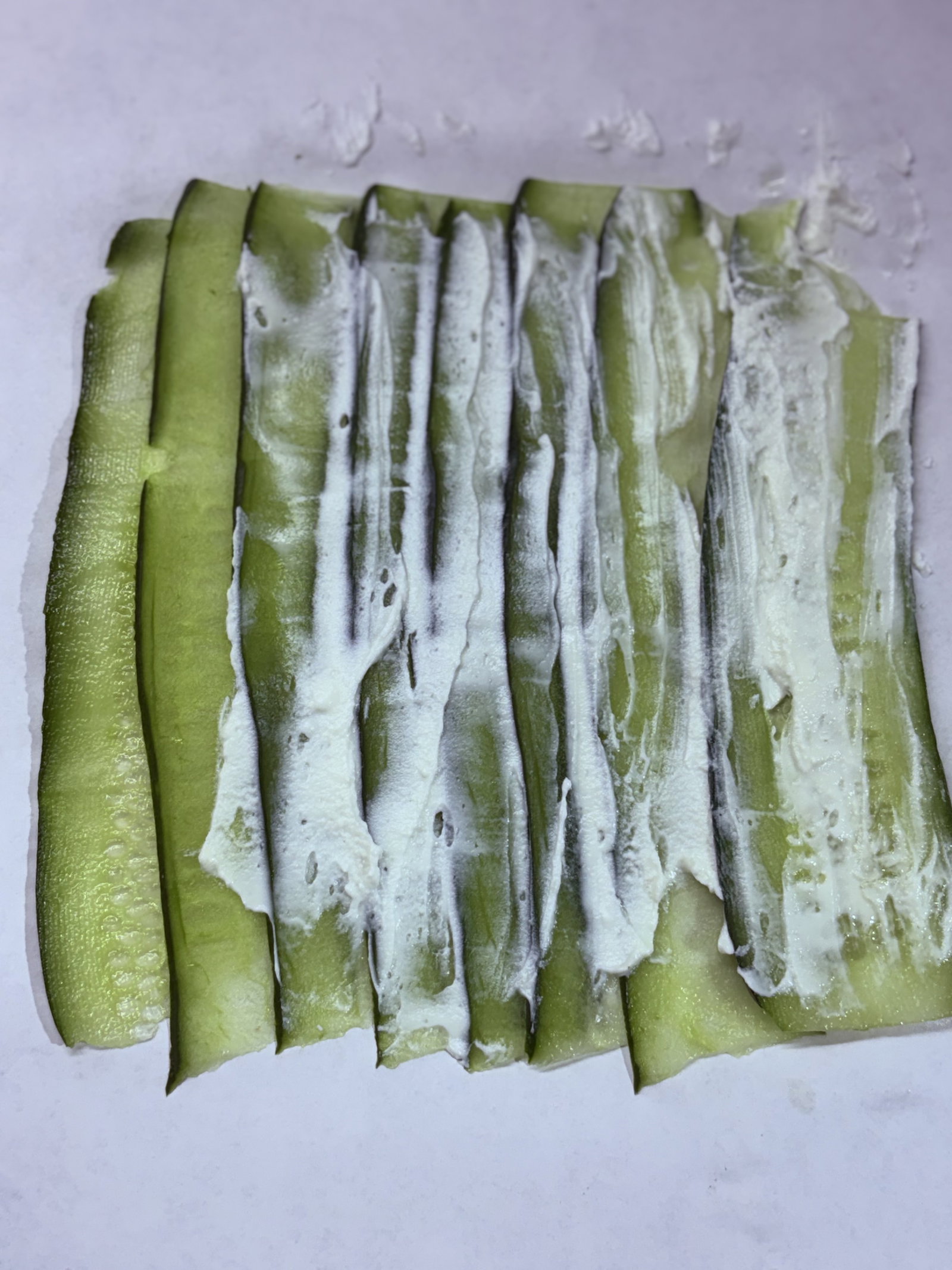 Step 4.1: Gently spread the plain salted curd over the cucumber mat