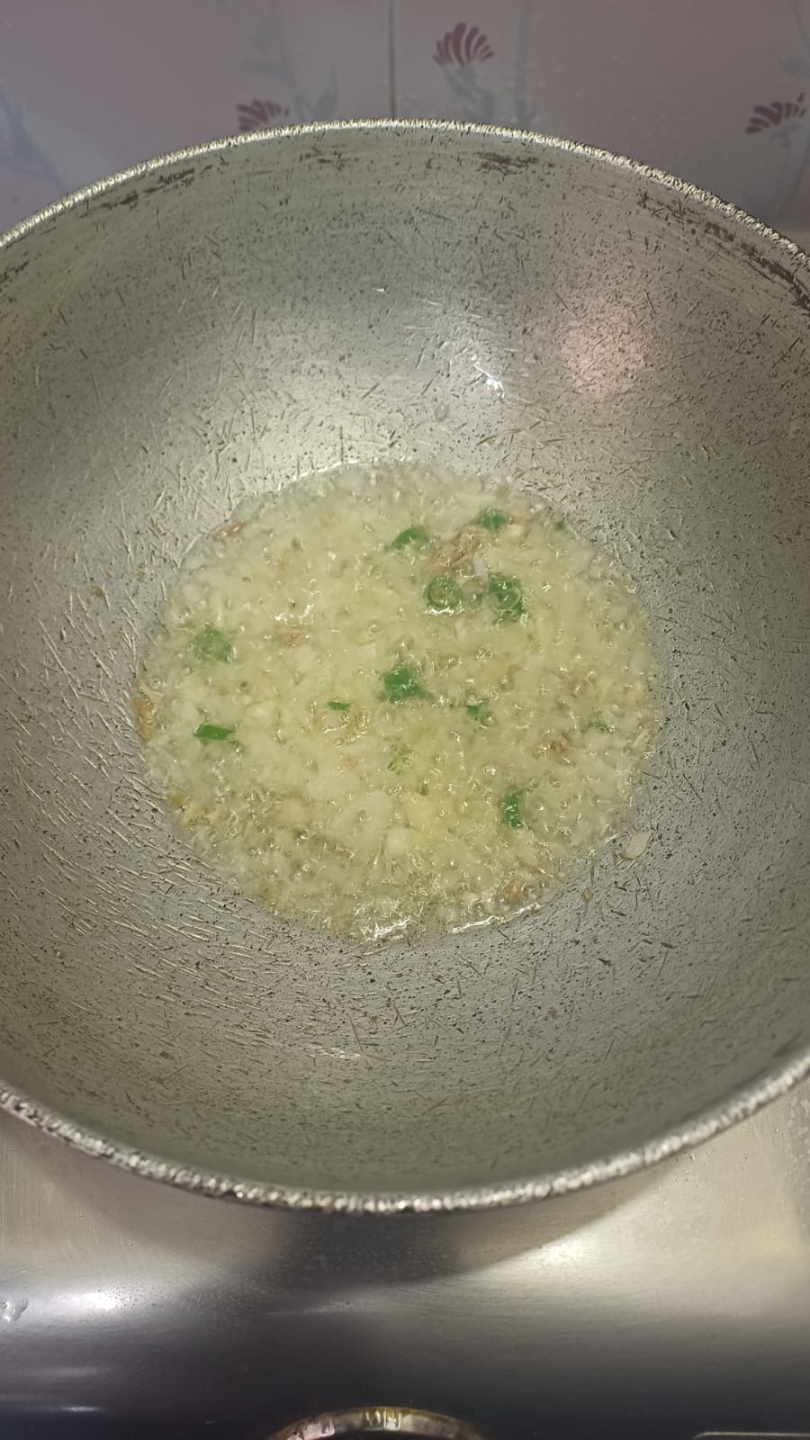 Step 2.2: Heat oil in a cooking pan and fry the onion for a min