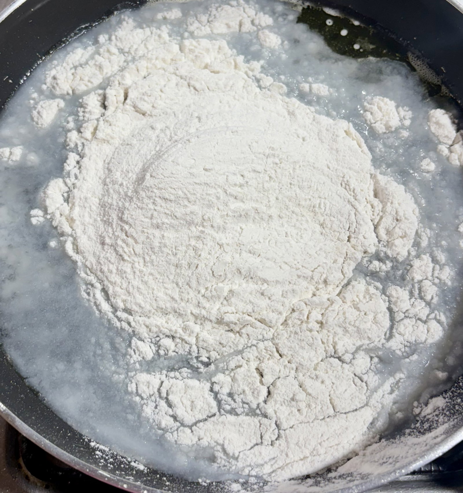 Step 1.1: Reduce the heat to low and add the rice flour all at once