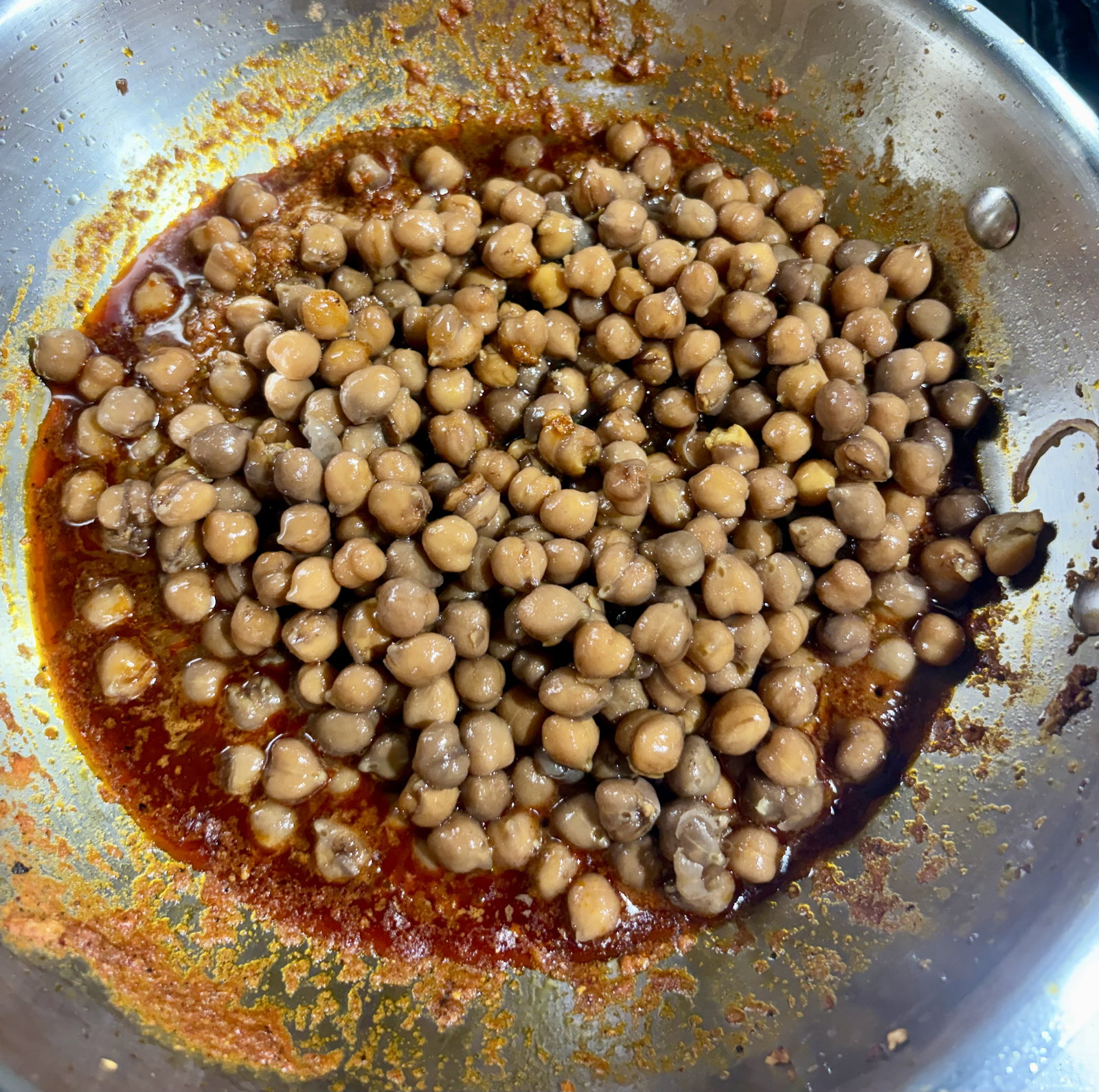Step 2.1: Add boiled channa and sauté for 1–2 minutes over high heat