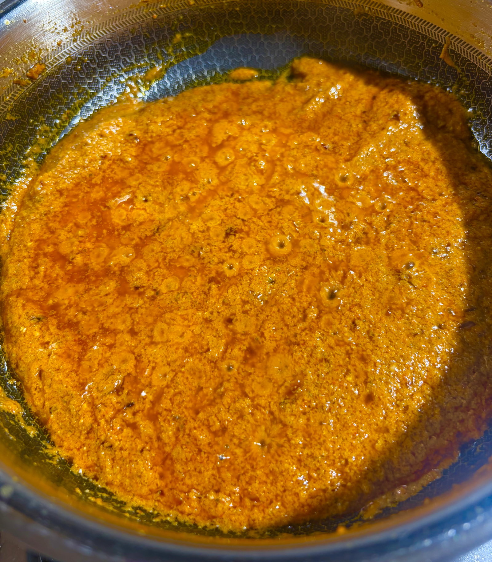 Step 3.2: Turn the heat to low, whisk in the yogurt, and stir constantly until the oil separates again