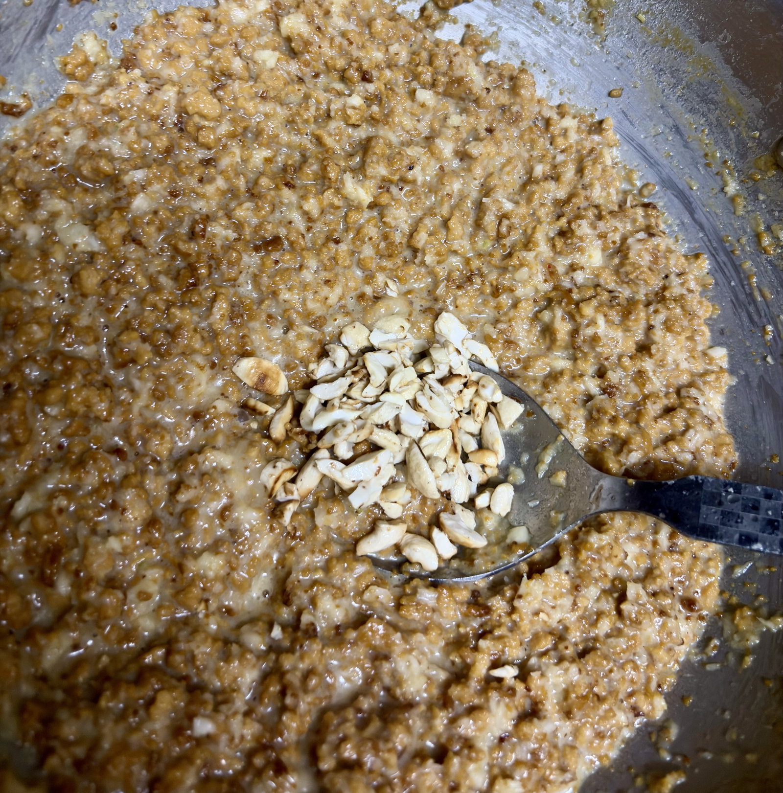 Step 5.1: Fold the roasted nuts back into the thickened mixture, stir well, and turn off the heat