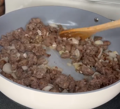 Step 1.1: Mix in the diced onions, garlic, dried basil, dried oregano, dried parsley, salt, and pepper, and sauté until the onions are translucent and fragrant