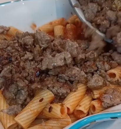 Step 1.1: In a greased baking dish, layer the noodles mixed with sauce, and top with the browned sausage