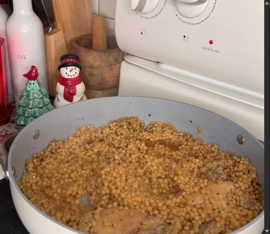 Step 2.1: Add chicken thighs back to the pan, lower heat, cover, and simmer for 10-15 minutes until the couscous is tender and the chicken is cooked through
