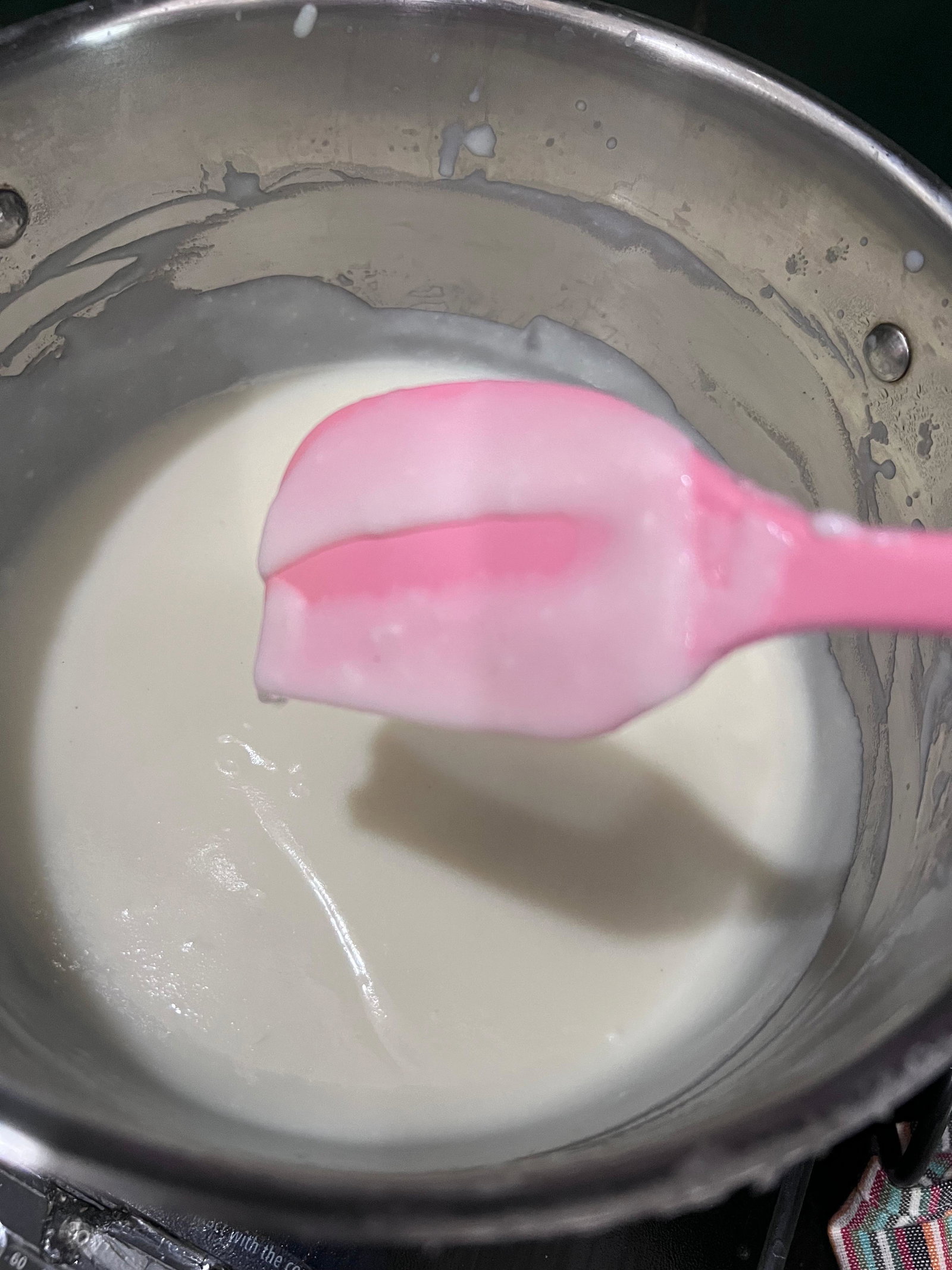 Step 1.3: Add sugar and continue cooking until the phirni coats the back of a ladle and a line drawn on it remains undisturbed
