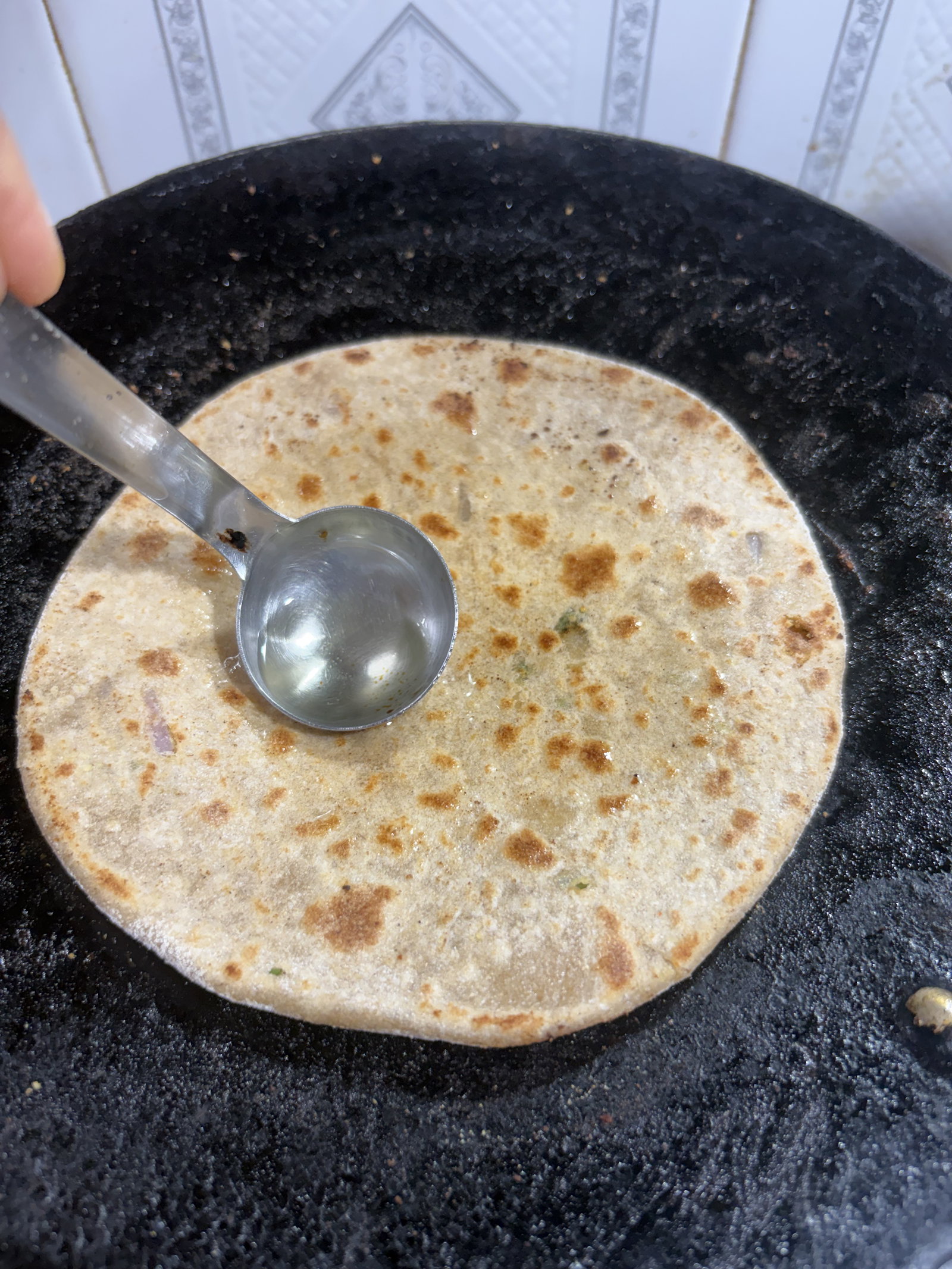 Step 4.1: Apply a teaspoon of ghee or oil on both sides