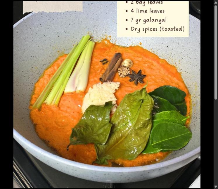 Step 4.1: Saute the spice paste with the lemongrass, bay leaves, lime leaves, galangal, and toasted dry spices until fragrant
