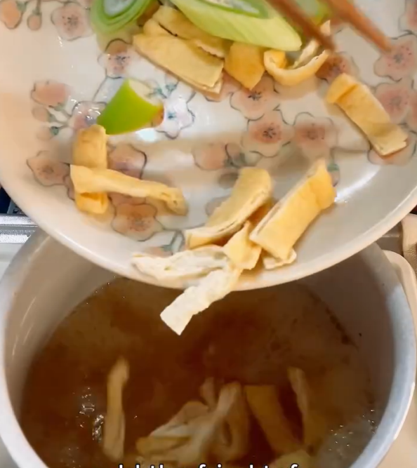 Step 1.1: Add the sliced Japanese leek and aburaage to the pot