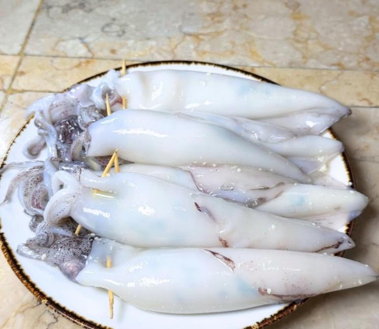Step 5.1: Fill each squid about 3/4 full with the filling and secure with a toothpick
