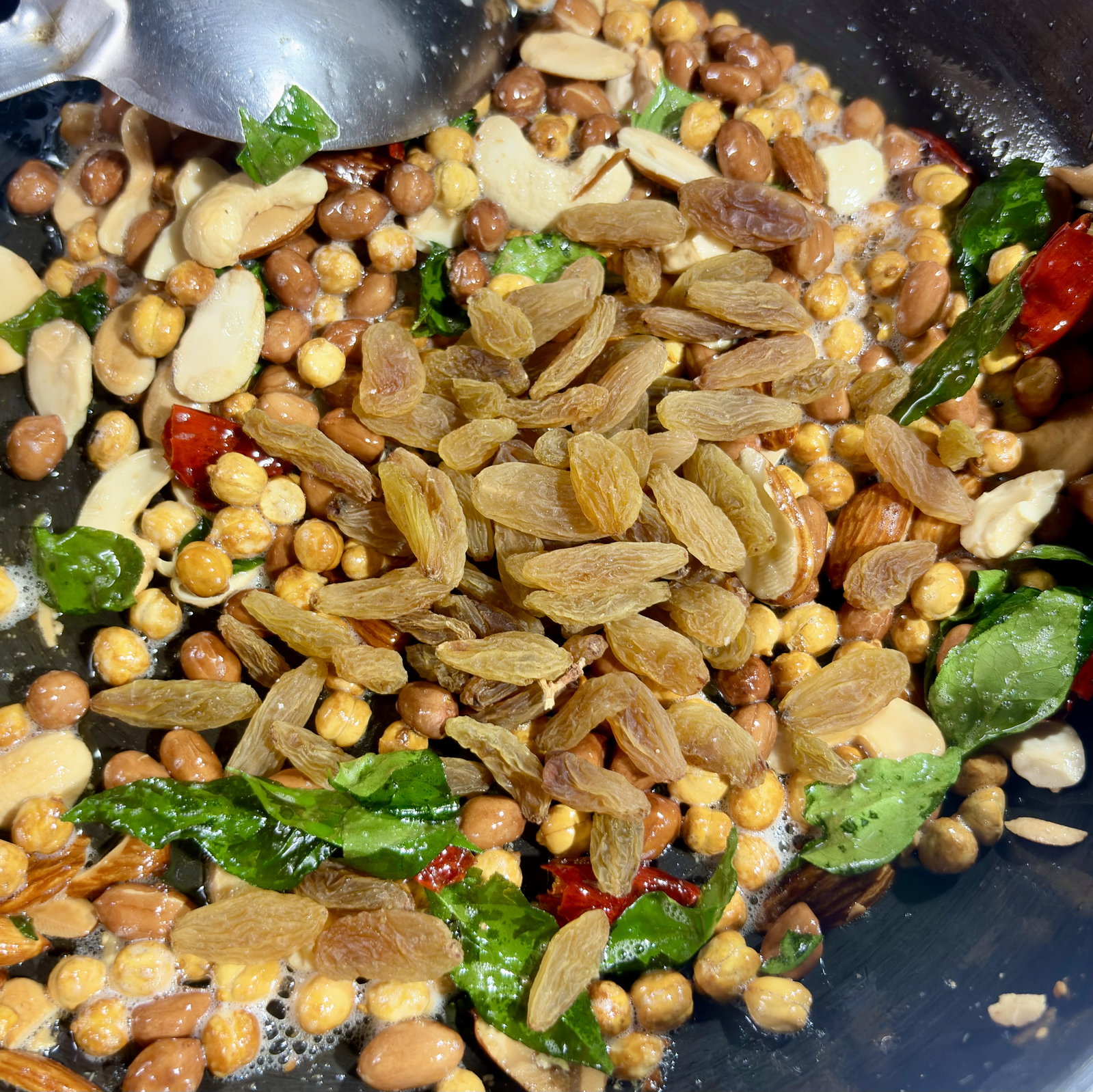 Step 2.1: Add the raisins and stir quickly for a few seconds just until they puff up