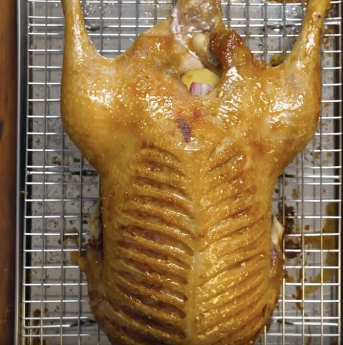 Step 2.1: After 20 minutes, begin lacquering the duck with the gastrique