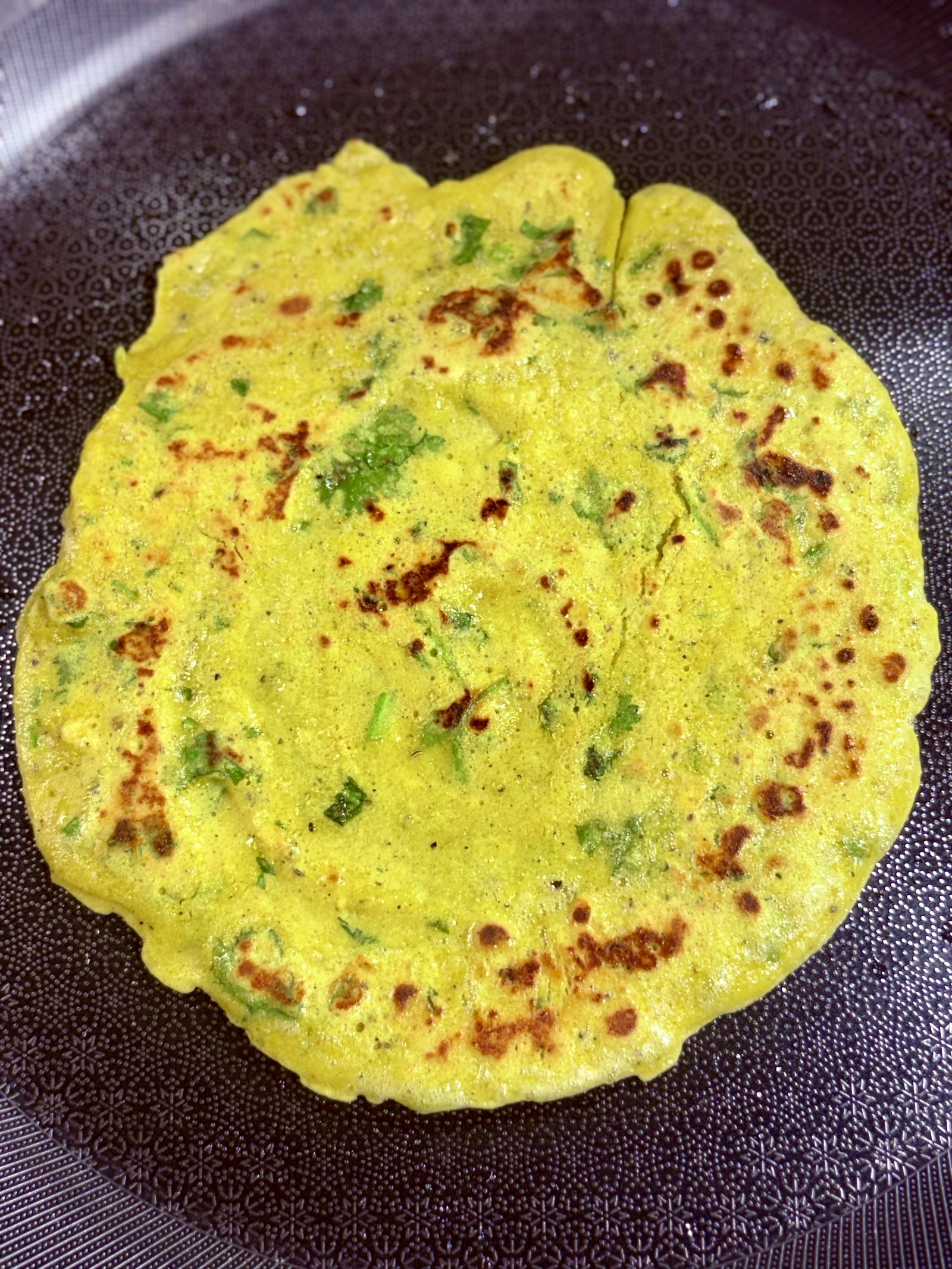 Step 1.1: Carefully flip the chilla and cook the other side for 1–2 minutes until it's fully cooked and slightly crisp