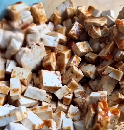 Step 1.1: Stir the tofu cubes into the mixture, ensuring they are fully coated