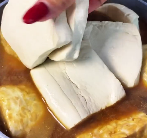 Step 5.1: Add the tempeh, tofu, and boiled eggs to the pot