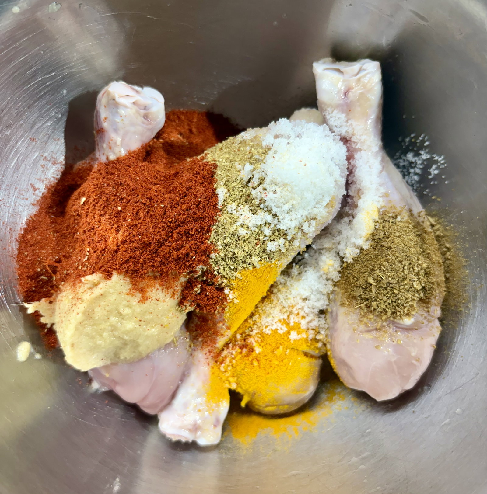 Step 1.1: Put the chicken drumsticks in a mixing bowl and add the lemon juice, ginger-garlic paste, Kashmiri chilli powder, coriander powder, cumin powder, turmeric powder, and salt