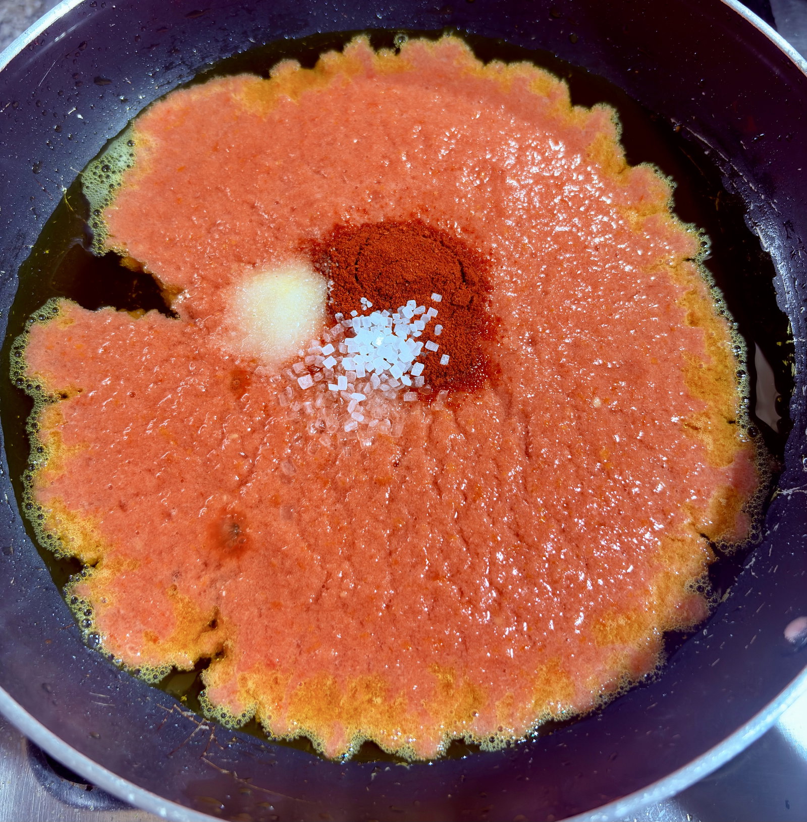 Step 3.1: Stir in Kashmiri red chilli powder, salt, and sugar, and cook on medium heat for 2–3 minutes