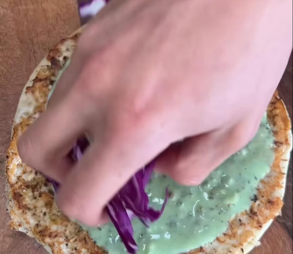 Step 4.1: Top the cooked pita with corn salsa, green yoghurt sauce, red cabbage, pickled jalapenos, lime juice, and coriander