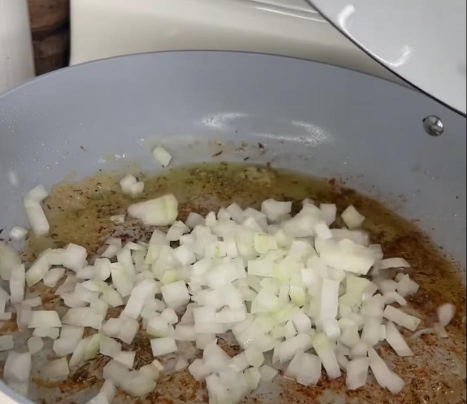 Step 2.1: Add diced onion and minced garlic to the pan and sauté until fragrant