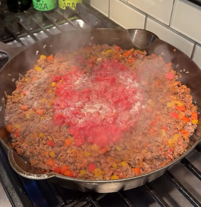 Step 1.1: Add diced tomatoes, chili powder, cumin, paprika, salt, and pepper