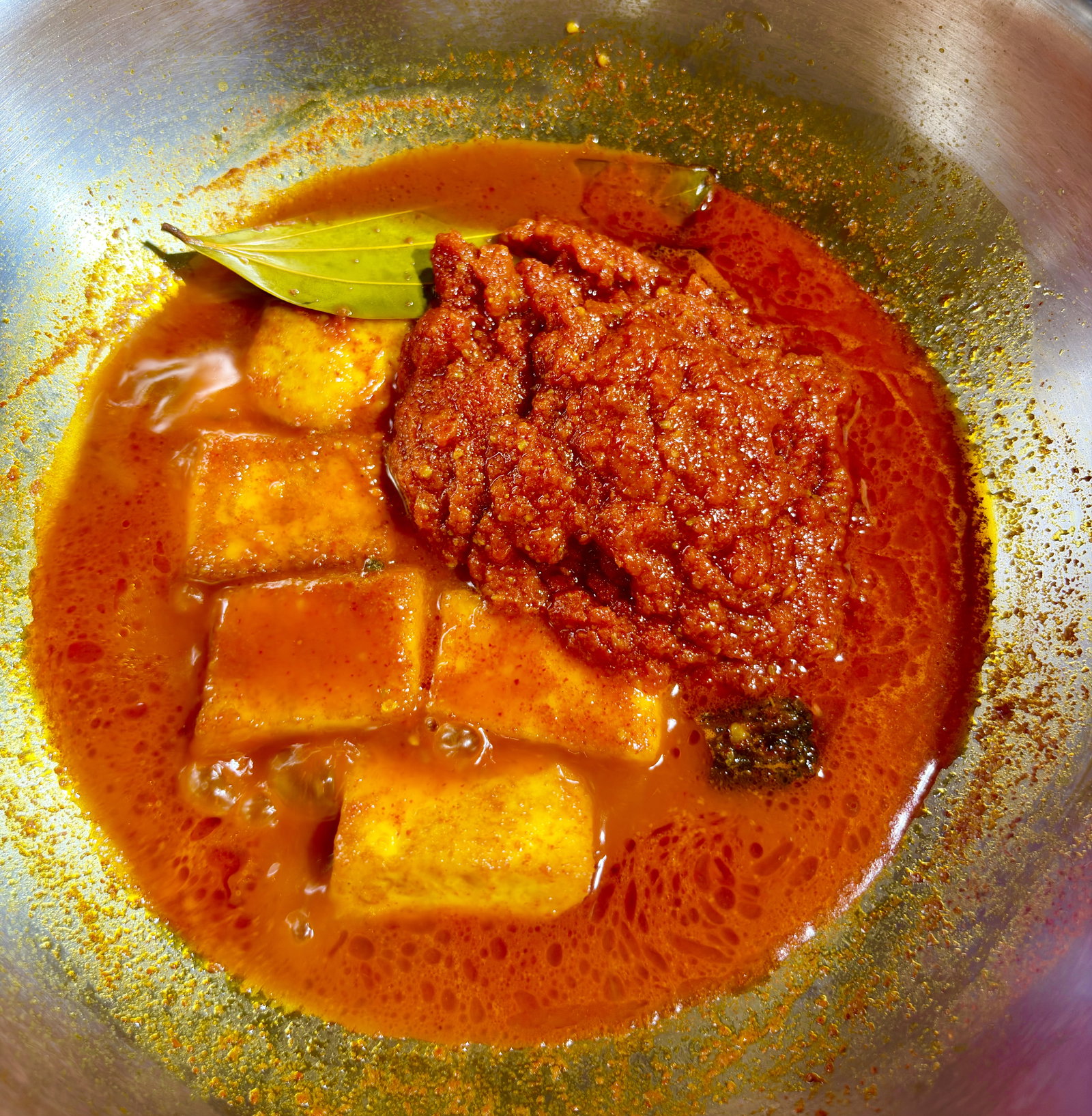 Step 5.1: Add the prepared tomato masala to the kadhai and stir gently to combine