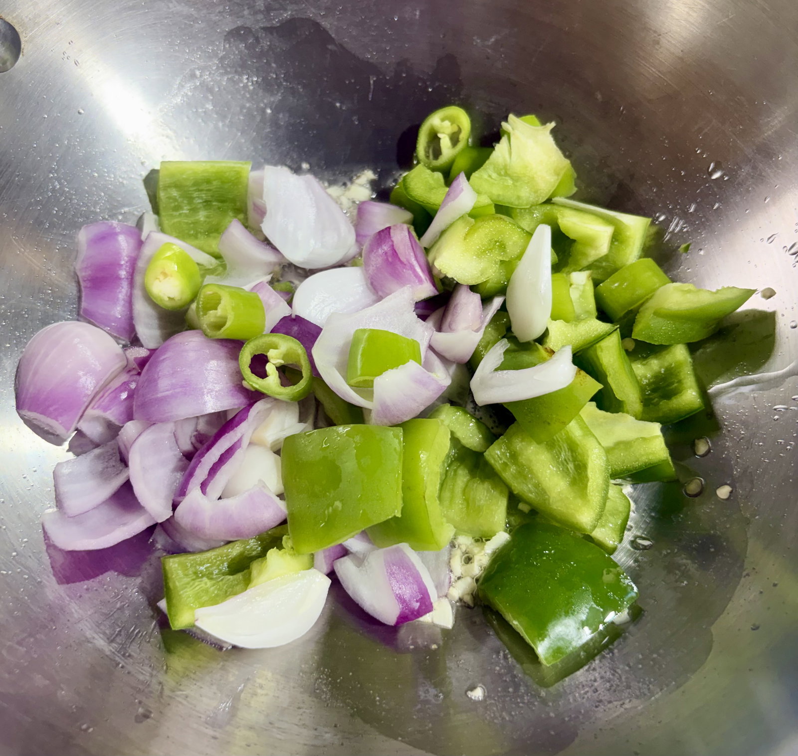 Step 2.1: Toss in cubed onion, capsicum, and sliced green chilli