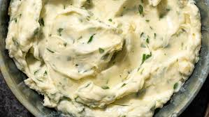 Step 1.1: Prepare garlic butter by mixing the melted butter and minced garlic, then brush it generously into the cuts of the bread