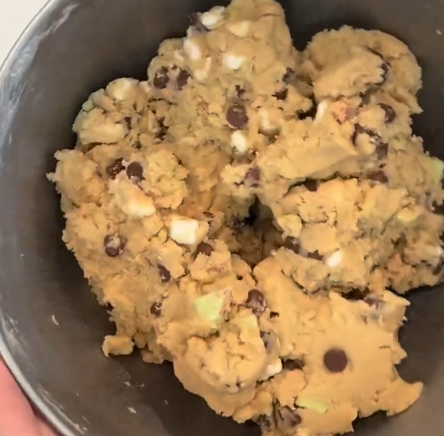 Step 1.2: Once mixed, pour in crushed Kit Kats and chocolate chips