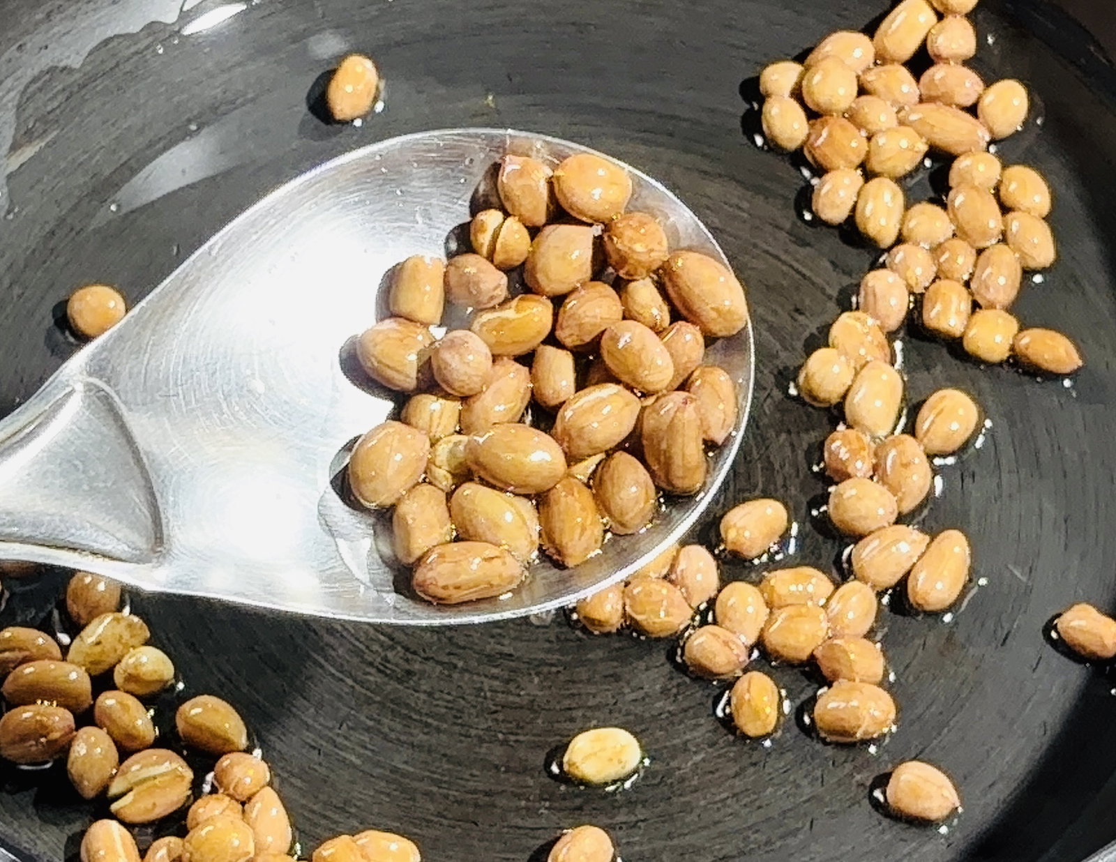 Step 2.1: Add the peanuts and roast for 2–3 minutes until golden and crackling