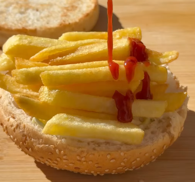 Step 2.1: Top the patty with grilled onions, grilled tomatoes, crispy fries, and coleslaw mixed with mayonnaise