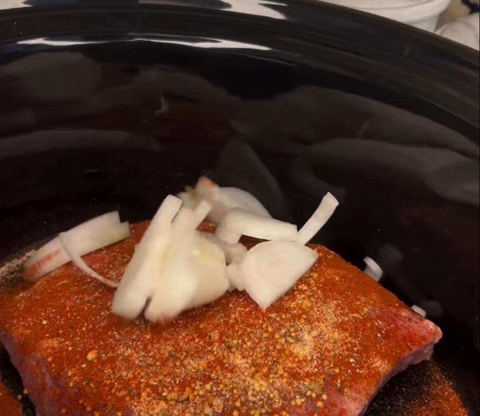 Step 1.1: Place the corned beef brisket in a slow cooker along with the pickling spice packet, garlic powder, onion powder, paprika, black pepper, white onion, garlic, beer, and beef broth