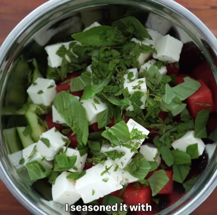Step 2.1: Inside the watermelon shell, layer cubes of cucumber, feta, and watermelon