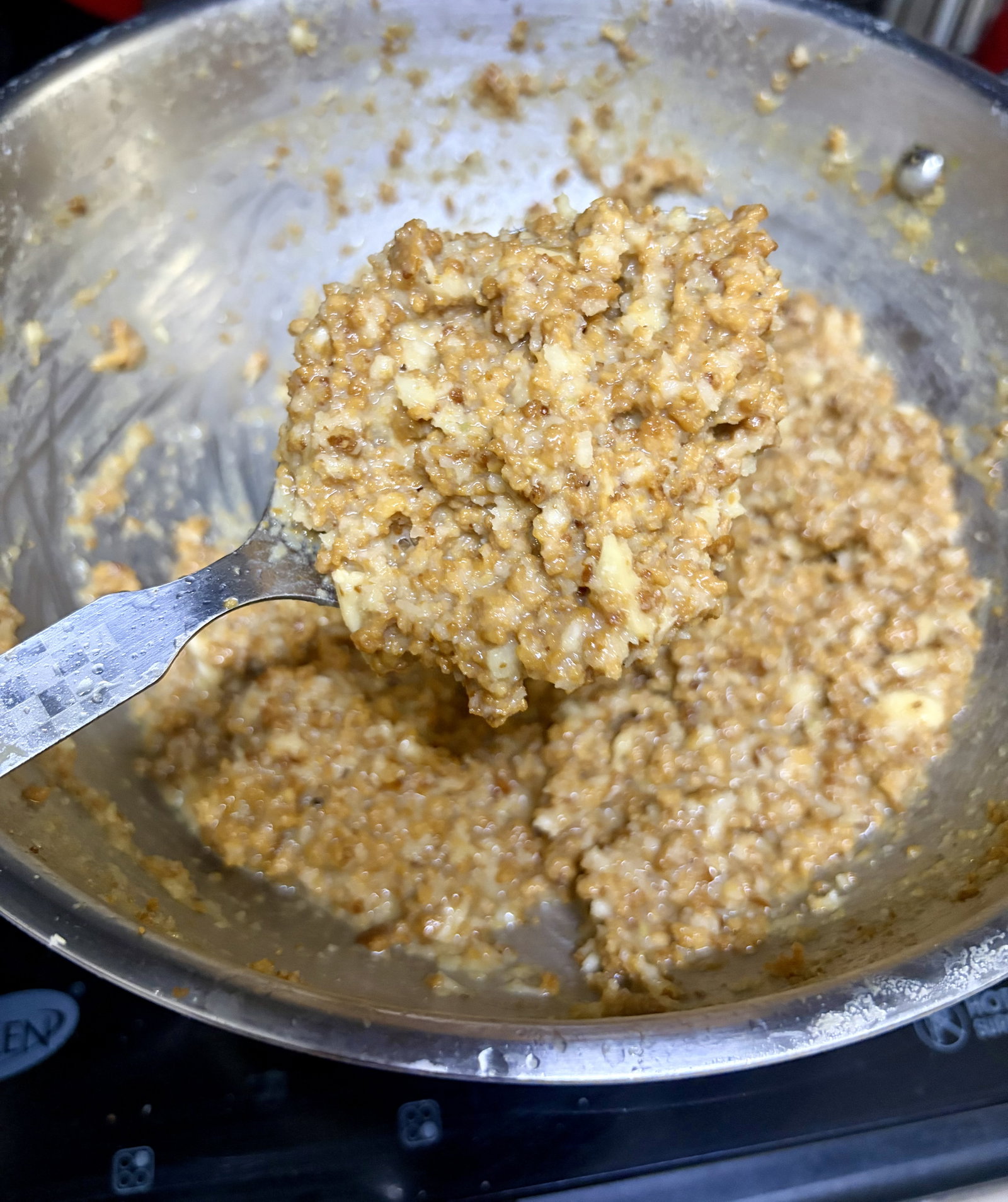 Step 5.2: Fold the roasted nuts back into the thickened mixture, stir well, and turn off the heat