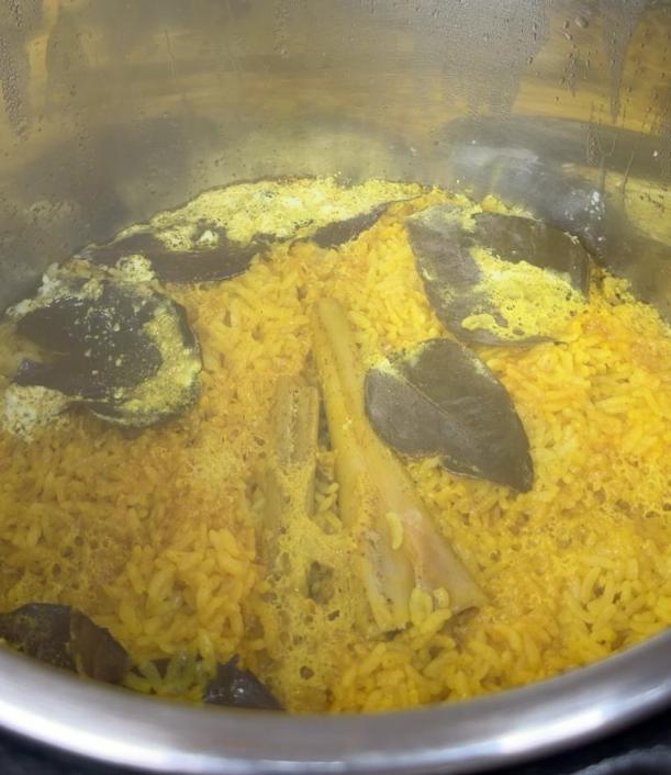 Step 1.1: Combine rice, water, coconut cream, turmeric powder, chicken stock powder, lemongrass, bay leaves, and lime leaves in a rice cooker or pot and cook until the rice is tender and fragrant