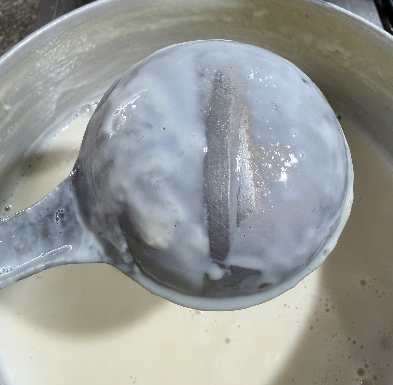 Step 1.1: **Test:** Dip a spoon or ladle into the mixture