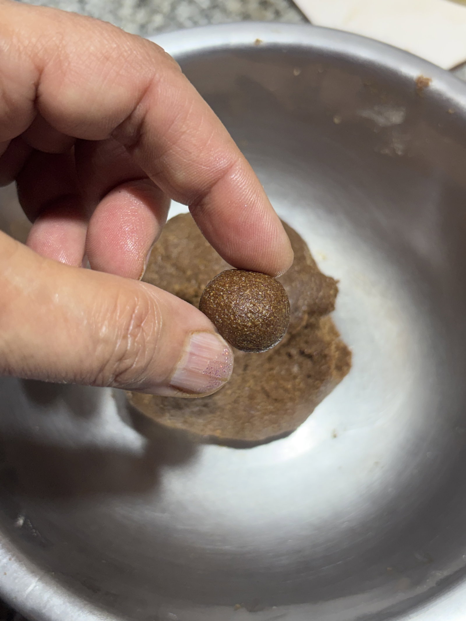 Step 4.1: Pinch small portions of the dough and roll them between your palms into smooth bite-sized balls